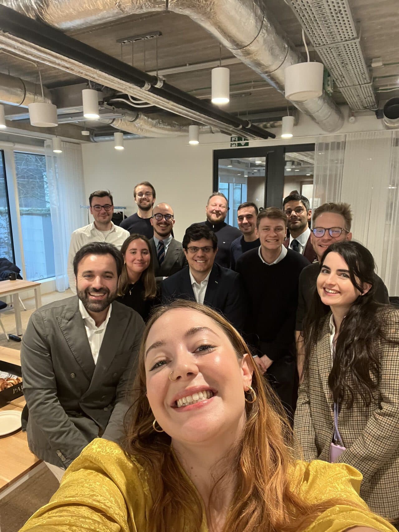 Workshop participants smiling together for a group selfie in a meeting room